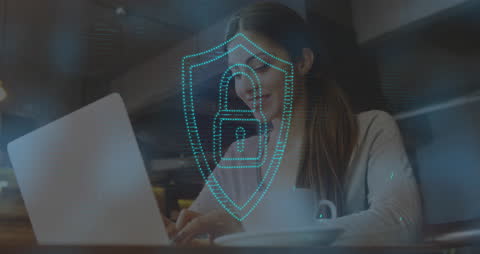 Woman in Cafe with Digital Security Hologram on Laptop