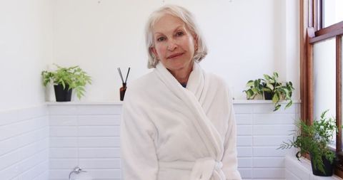 Senior Woman in Relaxed Bathroom Setting with Natural Light