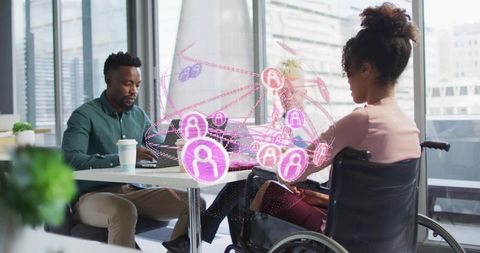 Inclusive team collaborating with ar network, woman in wheelchair using laptop