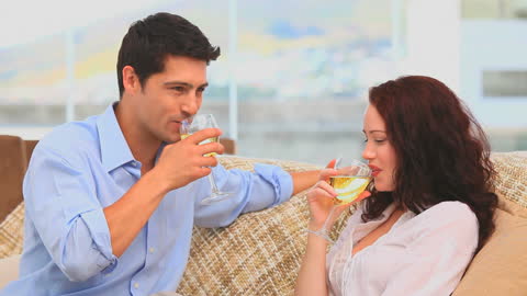 Relaxed Couple Enjoying Wine Together at Home