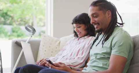 Happy Biracial Couple with Technology at Home