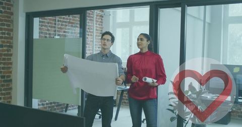 Colleagues Discussing Blueprints in Modern Office Space