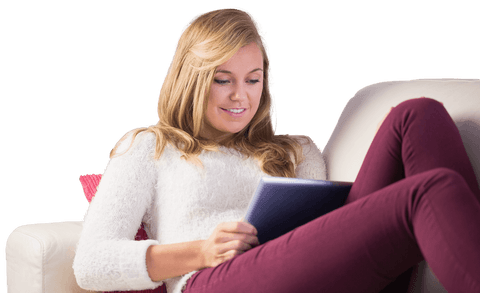 Smiling Woman Relaxing on Couch with Tablet in Cozy Living Room