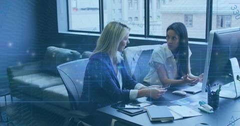 Diverse professionals collaborating with virtual data overlay in modern office