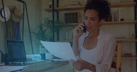 Woman Multitasking in Home Office with Phone and Documents