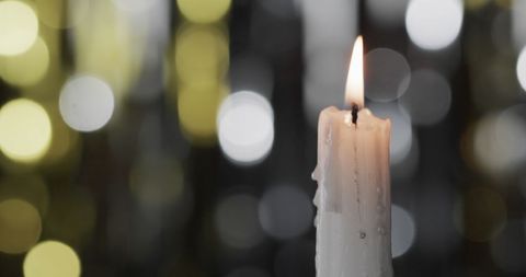 Christmas Candle with Festive Bokeh Lights