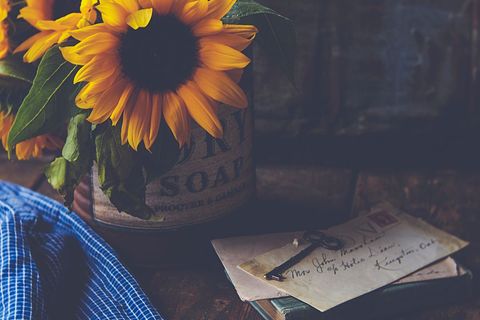 Vintage Sunflowers and Letter Arrangement on Wooden Table