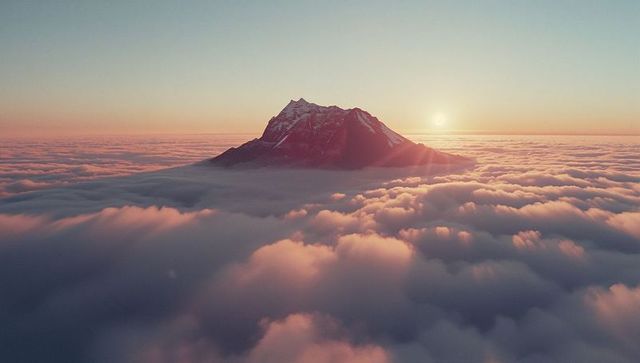 Majestic Snow-Capped Mountain at Sunrise Over Clouds