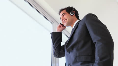 Businessman Engaging in Conference Call with Headset