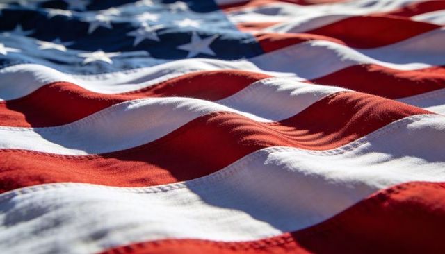 Waving united states flag close-up showing fabric texture, stitched seams and stars