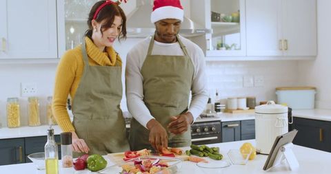 Festive couple cooking together in modern kitchen at home