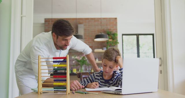 Father tutoring son at home with abacus and laptop - Download Free Stock Images Pikwizard.com