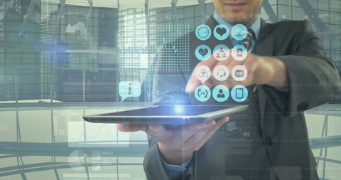 Businessman Holding Tablet with Holographic Digital Interface Icons - Download Free Stock Images Pikwizard.com