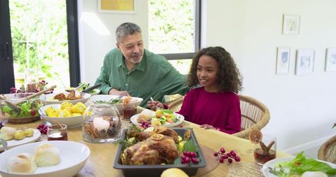 Sunlit Multigenerational Meal with African American Child at Rustic Family Dining Table