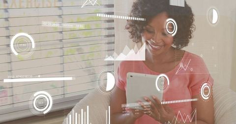 Smiling Woman Analyzing Data on Tablet with Transparent Infographics