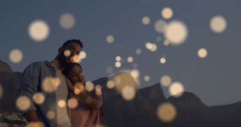Romantic Couple Under Golden Bokeh Circles Outdoors