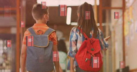 Students walking down school corridor with backpacks