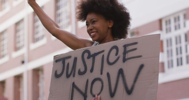 African american woman holding placard shouting raising fist during protest - Download Free Stock Photos Pikwizard.com