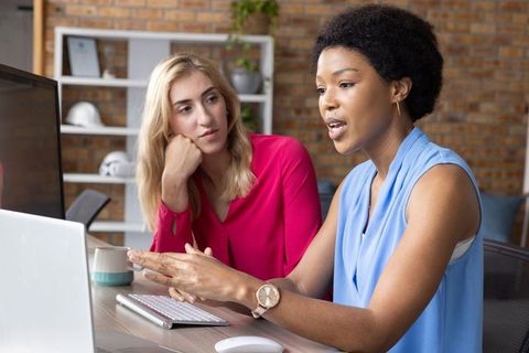 Diverse Coworkers Discussing Project in Modern Office Environment
