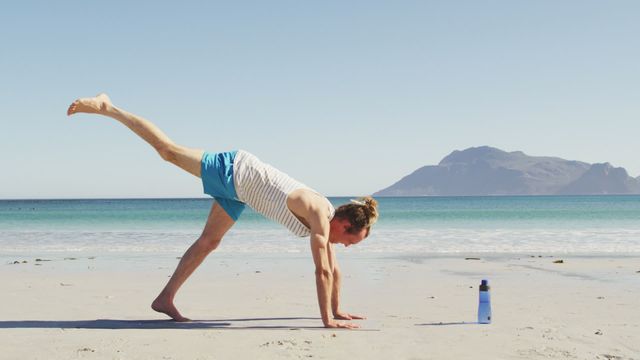 Caucasian man with dreadlocks practicing yoga on a sunny beach. Scene captures wellness, serenity, and an active lifestyle surrounded by nature. Can be used to promote physical exercise, mindful living, health retreats, or vacation destinations centered on relaxation and fitness.