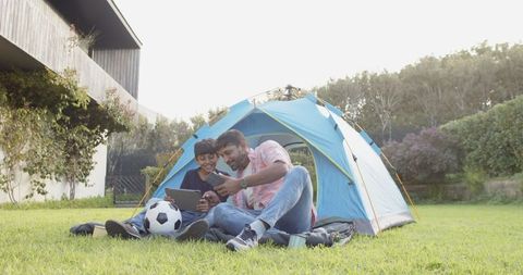 Family Camping Experience Using Tablet and Watching Match