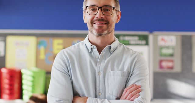 Smiling Teacher in Classroom with Arms Crossed - Download Free Stock Images Pikwizard.com