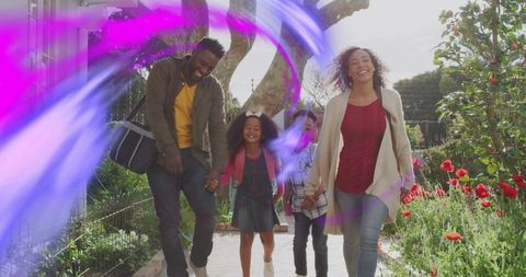 Smiling family walking hand in hand through sunlit garden path with vibrant light streaks