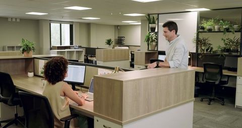 Coworkers Having Productive Discussion in Modern Office Environment