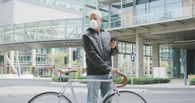 Older man with bicycle wearing mask on urban street - Download Free Stock Images Pikwizard.com