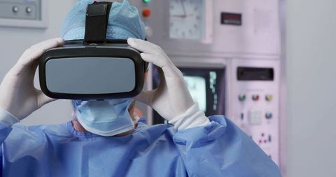 Surgeon wearing vr headset conducting surgical simulation in high-tech training lab