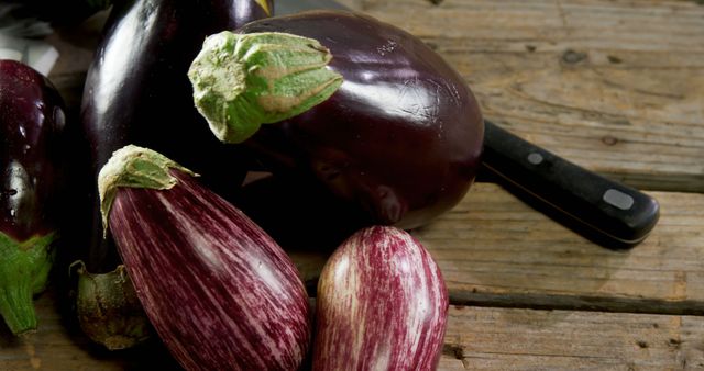 Fresh Eggplants on Wooden Table with Knife - Download Free Stock Images Pikwizard.com