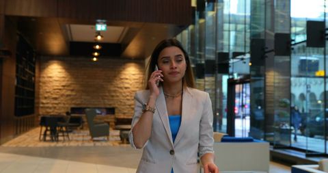 Businesswoman Communicating on Mobile Phone in Modern Office - Download Free Stock Images Pikwizard.com