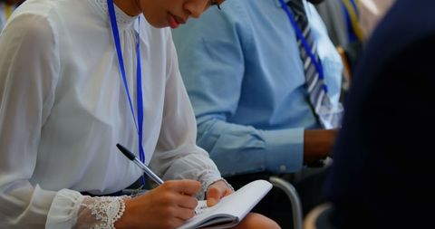 Business People Taking Notes at Seminar