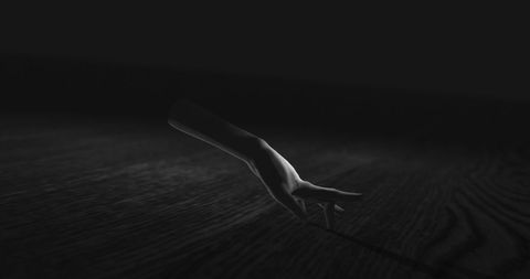 Creepy Hand Emerging from Shadows with Eerie Atmosphere