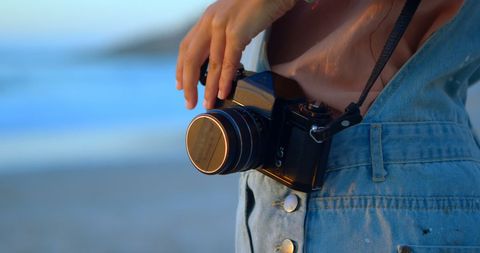 Vintage Camera Held by on Beach at Sunset