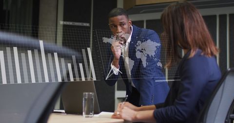 Diverse coworkers analyzing global business data on transparent screen