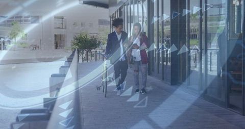 Colleagues Evaluating Ideas on Digital Tablet in Urban Plaza