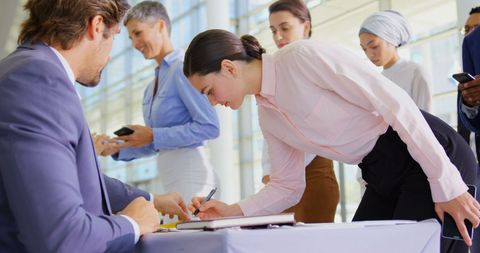 Business People Checking in at Conference Registration Table - Download Free Stock Images Pikwizard.com