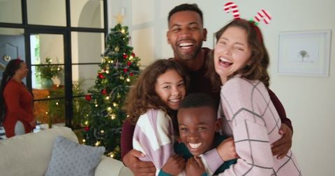 Cheerful family celebrating christmas with hugs and smiles