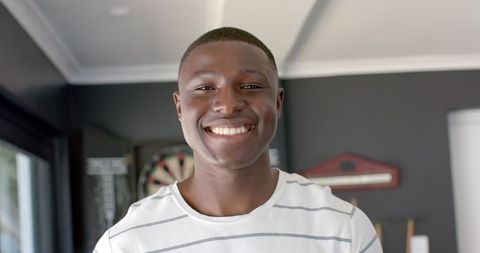 Cheerful Smiling Young African American Man in Cozy Home Environment