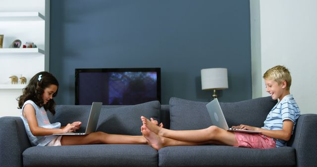 Kids Using Laptops on Couch in Living Room - Download Free Stock Images Pikwizard.com