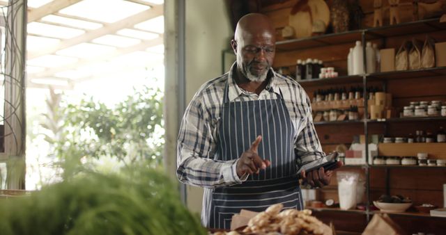 Senior Man Running Small Grocery Business Checking Inventory on Tablet - Download Free Stock Images Pikwizard.com