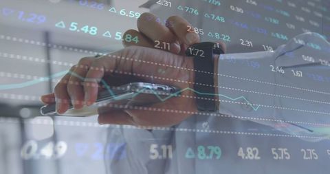 Businessman Interacting with Device Overlaid by Digital Stock Market Data