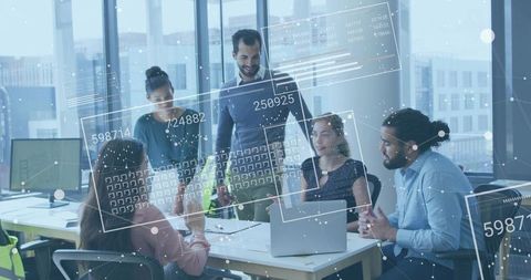 Manager presenting analytics to collaborative team around laptops with interactive overlays