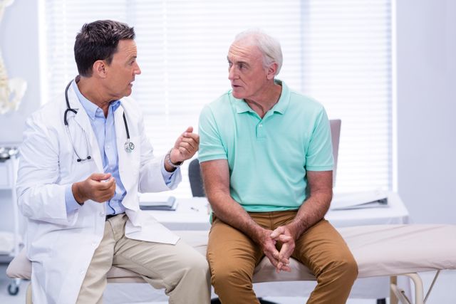 Doctor consulting senior patient in clinic. Useful for healthcare, medical advice, elderly care, and patient-doctor interaction themes. Ideal for articles, brochures, and websites focusing on senior health, medical consultations, and healthcare services.