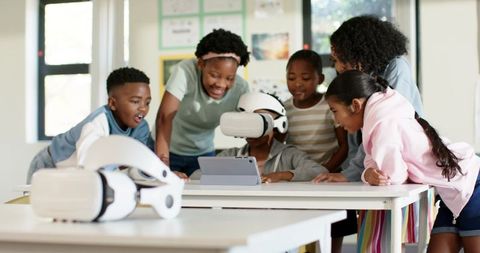 African American Children Exploring Virtual Reality Headset and Tablet in Classroom