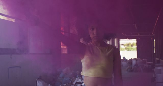 Young African American Woman with Purple Smoke in Urban Warehouse - Download Free Stock Images Pikwizard.com