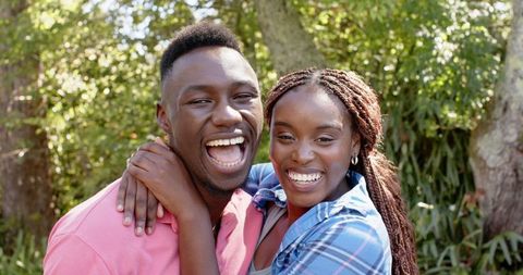 Joyful Bonding African American Couple Embracing Outdoors in Nature Scene