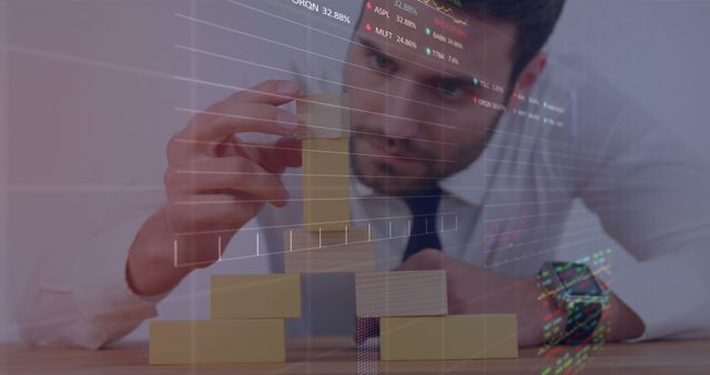 Businessman building structure with wooden blocks, superimposed with financial graphs. Useful for depicting strategic planning, business decision making, data analysis in corporate settings, financial consulting, and office productivity. Ideal for websites or materials involving finance, business strategy, and analytic tools.
