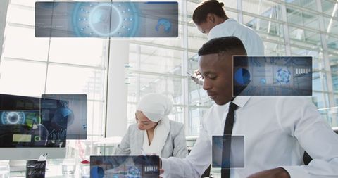 Diverse Coworkers Analyzing Data with Innovative Technology